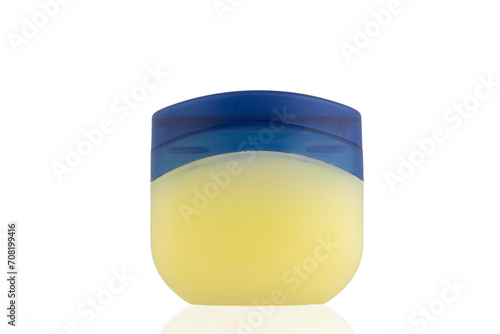 Vaseline Bottle on a white background. 
Jar for petroleum jelly. 
Yellow plastic container with blue lid.