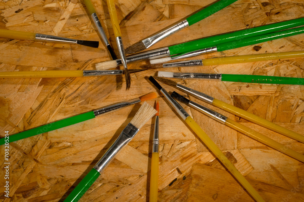 Fototapeta premium Paint brushes on wooden background 