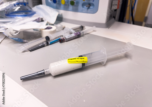 Syringes, needles, and vials of anesthesia neatly arranged on a sterile surface, symbolizing precision and care in healthcare settings