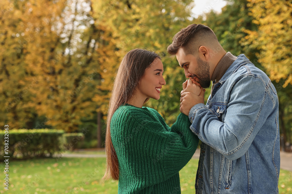 Romantic young couple spending time together in autumn park, space for text Romantic young couple spending time together in autumn park, space for text