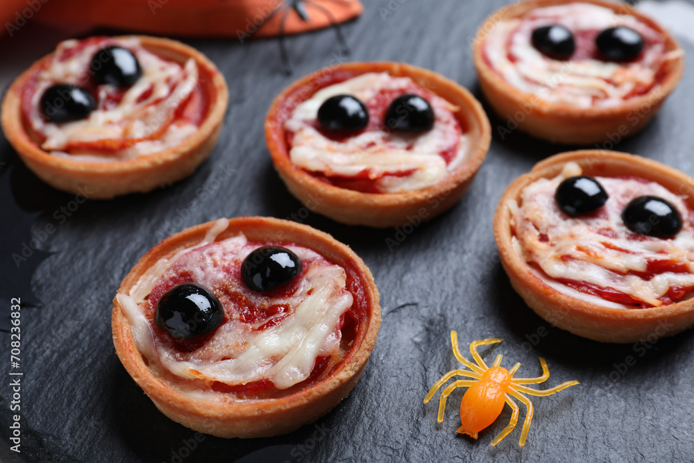 Cute monster tartlets served on slate plate, closeup. Halloween party food Cute monster tartlets served on slate plate, closeup. Halloween party food