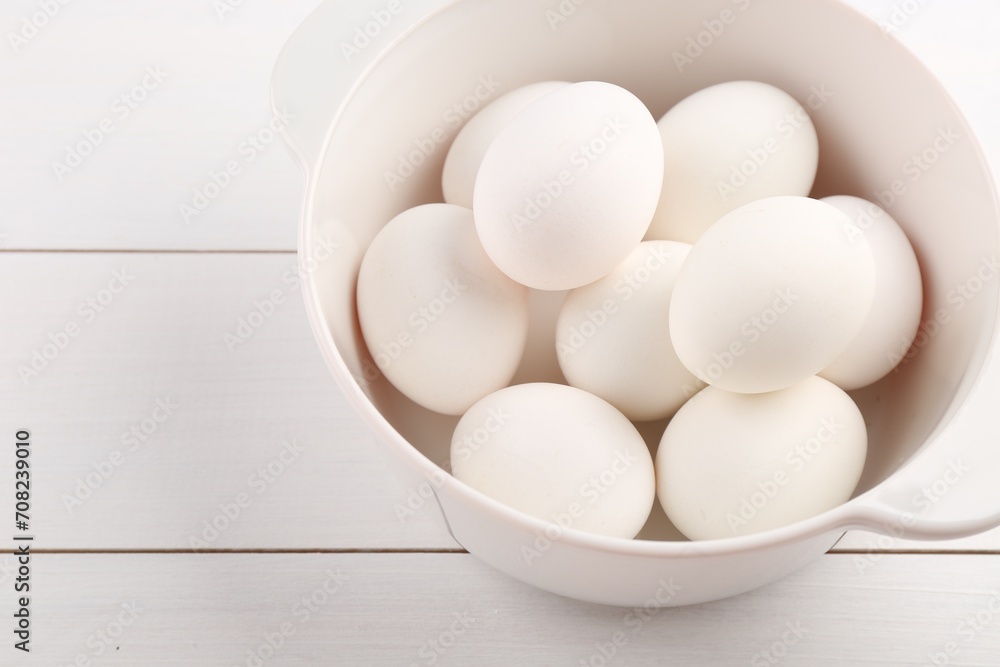 Boiled eggs in saucepan on white wooden table, closeup. Space for text Boiled eggs in saucepan on white wooden table, closeup. Space for text