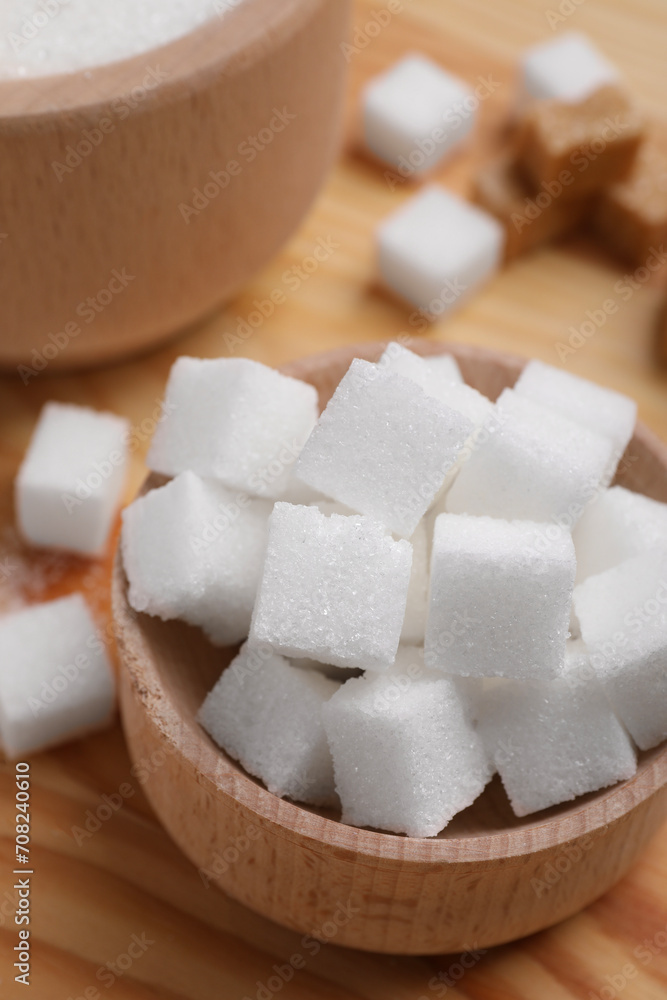 White sugar cubes in bowl on table, above view White sugar cubes in bowl on table, above view