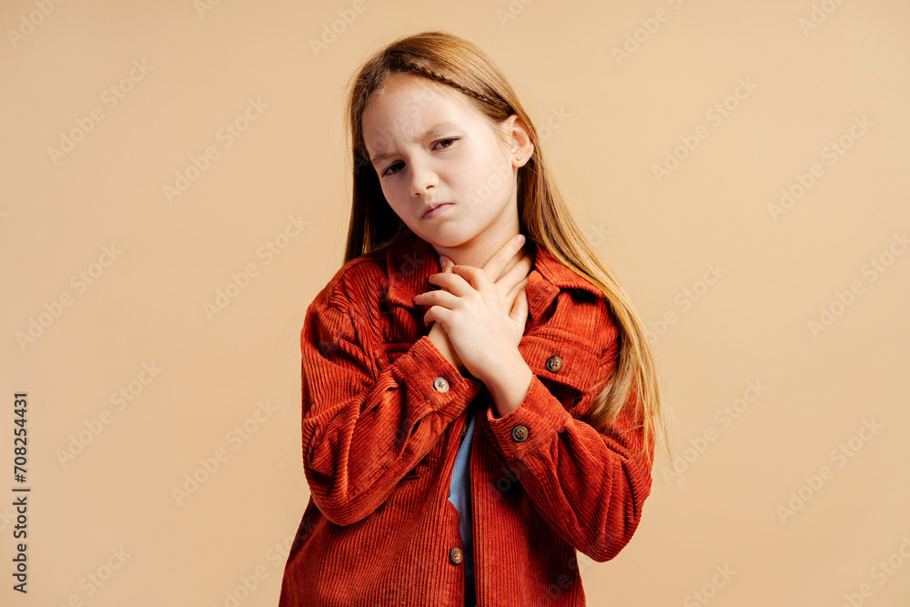 Portrait of sick little girl wearing casual jacket has sore throat looking at camera Portrait of sick little girl wearing casual jacket has sore throat looking at camera