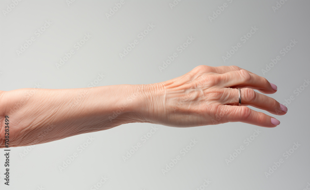 Hand of an elderly woman on light gray background. An open hand. Hand of an elderly woman on light gray background. An open hand.