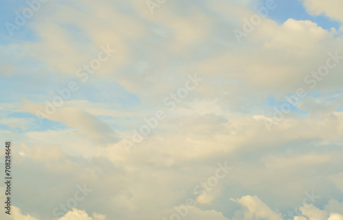 A blue cloudy sky with many small clouds blocking the sun