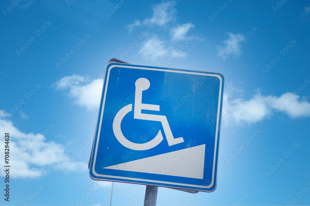 Signs for disabled with blue sky background Signs for disabled with blue sky background