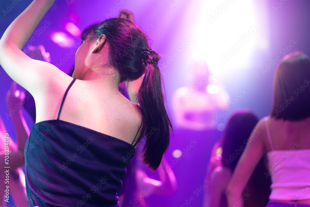 Asian thai girl drinking in night club. diverse young people dancing in night club. Nightlife and disco dance party concept. Fun music festival