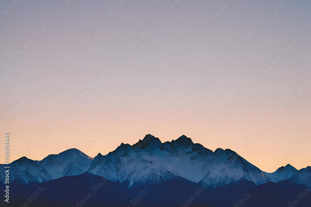 A silhouette of a mountain range with snow-capped peaks against the backdrop of a clear blue sky during sunset A silhouette of a mountain range with snow-capped peaks against the backdrop of a clear blue sky during sunset