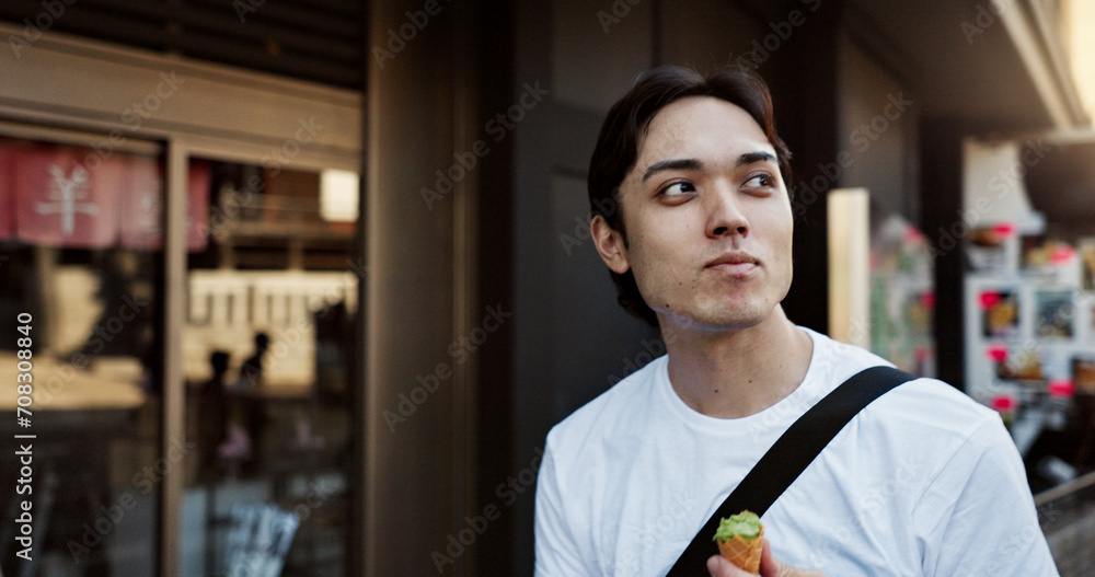 Fototapeta premium Walking, travel and Japanese man with ice cream in city on vacation, holiday and adventure in Yokohama town. Summer, weekend trip and person with dessert, sweet snack and cone for tourism destination