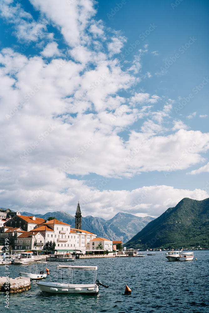 Excursion boats are moored at the pier overlooking the resort town of Perast. Montenegro