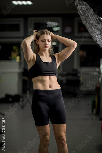 Portrait of a young beautiful girl working out in the gym.