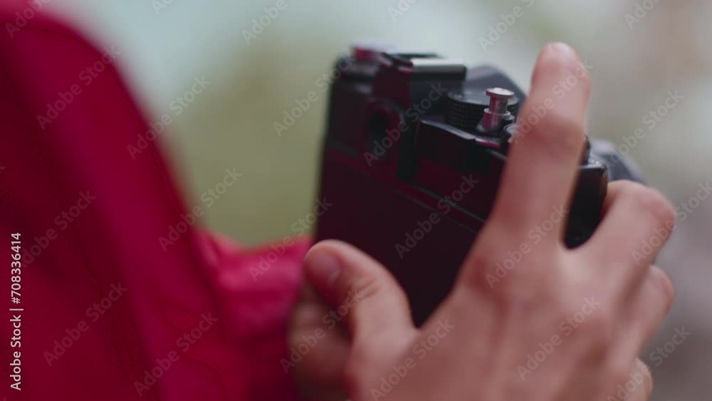 retro camera. the girl changes the film in the camera. the photographer sets up the camera before shooting. retro camera. the girl changes the film in the camera. the photographer sets up the camera before shooting.
