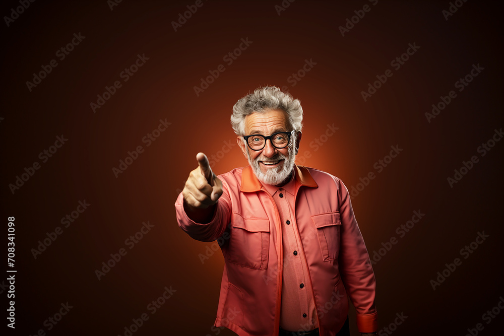 Senior man points with his hand and finger to the side and looks into the camera. Copy space. Senior man points with his hand and finger to the side and looks into the camera. Copy space.