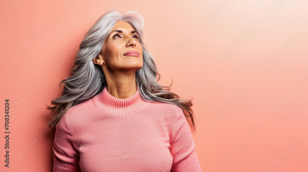Close up of a confident middle aged woman with a peach copyspace background Close up of a confident middle aged woman with a peach copyspace background