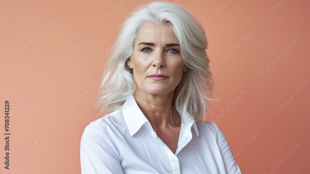 Close up of a confident middle aged woman with a peach copyspace background Close up of a confident middle aged woman with a peach copyspace background