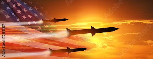Fired missiles fly to the target. USA flag. Missiles at the sky at sunset. Missile defense. Rockets attack concept. 3d illustration photo