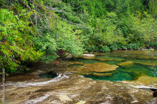 Pot holes under the emerald waters of the mountain river.