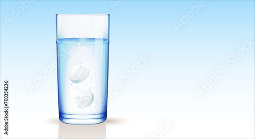 Transparent glass with water and effervescent, instant tablets with bubbles, blue gradient background. Copy space.