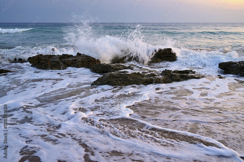 Sea at sunset with waves on the beach. Greece - the island of Corfu.