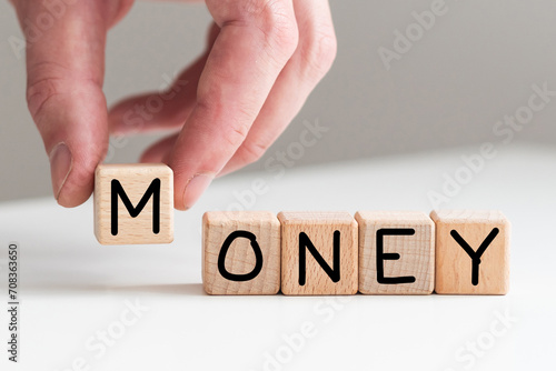 Spend or make money symbol. Businessman turns cubes and changes concept words Spend money to Make money. Beautiful white table white background. Business spend or make money concept. Copy space.