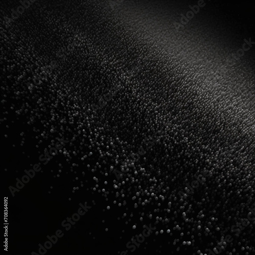 A Dense Dark Cluster of Small Gray Pellets on a Solid Black Background