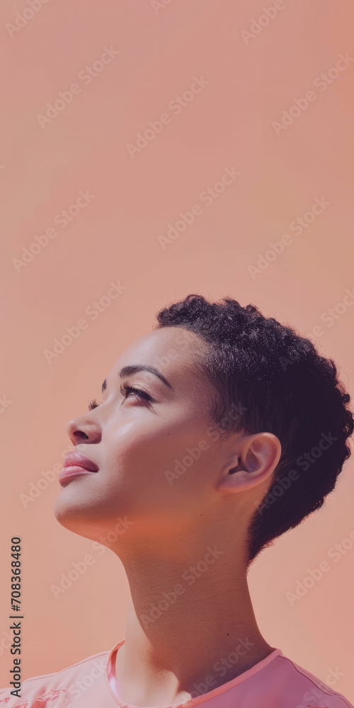 Close up of a confident young woman with a peach copyspace background for text