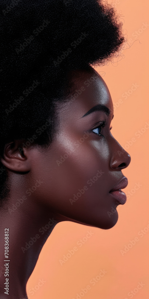 Fototapeta premium Close up of a confident young woman with a peach copyspace background for text