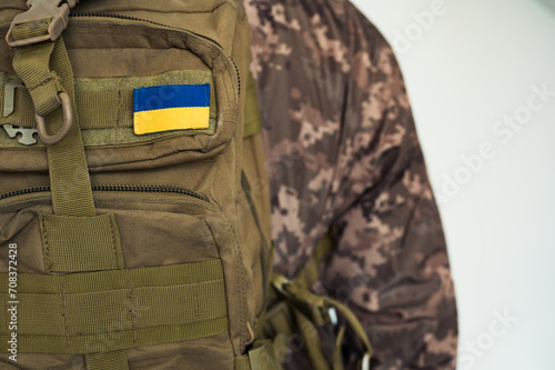 Ukrainian soldier combat in pixel military uniform with tactic backpack coyote color and flag of Ukraine