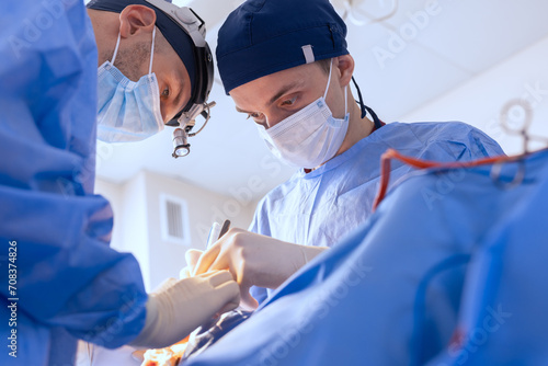 male surgeons perform surgery in operating room, plastic surgeon in operating room photo