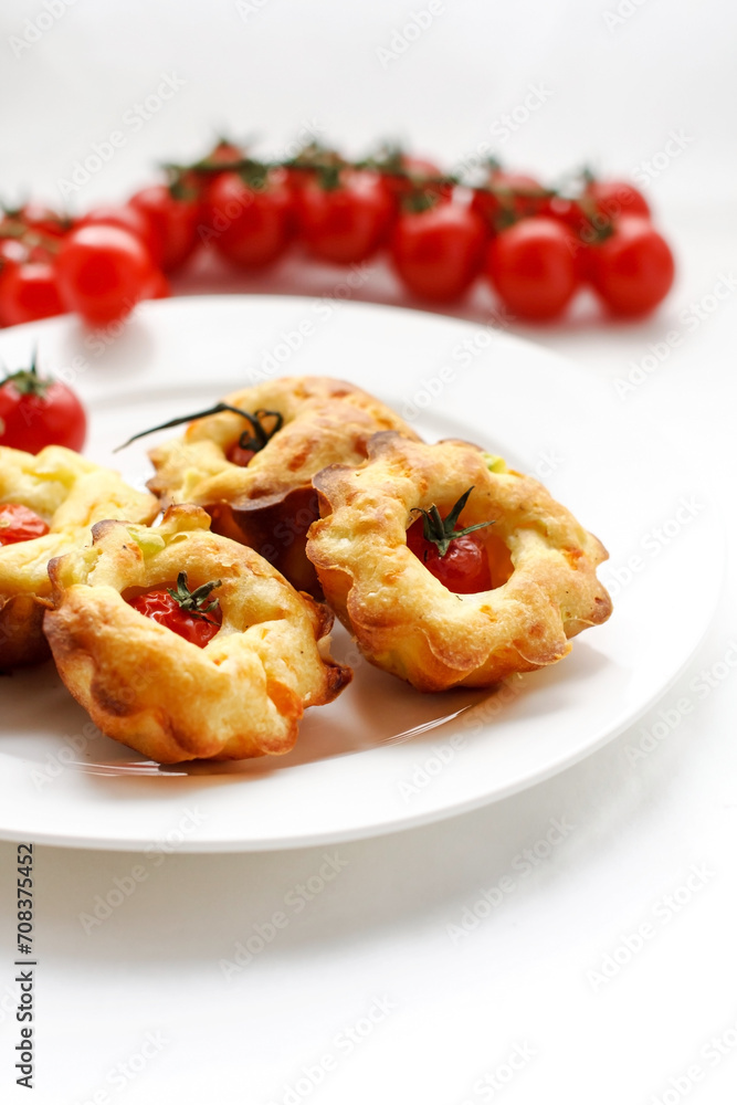 cakes with cherry tomatoes on white plate cakes with cherry tomatoes on white plate