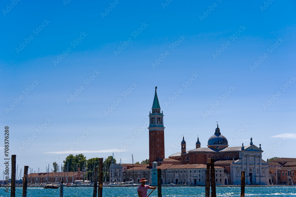 Old town of Italian City of Venice with skyline and Basilica di San Giorgio Maggiore in the background on a sunny summer day. Photo taken August 7th, 2023, Venice, Italy.