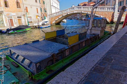 Scenic view of Guglie Bridge with garbage ship at the old town of Italian City of Venice on a sunny summer morning. Photo taken August 7th, 2023, Venice, Italy.