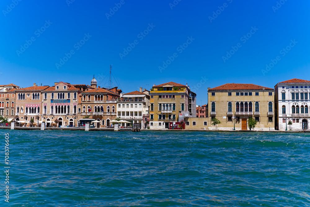 Old town of Italian City of Venice with colorful facades of historic houses and church tower seen from Canale san Giorgio on a sunny summer day. Photo taken August 7th, 2023, Venice, Italy. Old town of Italian City of Venice with colorful facades of historic houses and church tower seen from Canale san Giorgio on a sunny summer day. Photo taken August 7th, 2023, Venice, Italy.