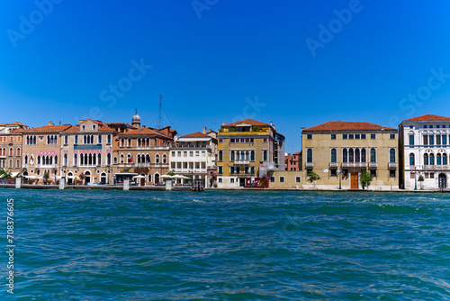 Old town of Italian City of Venice with colorful facades of historic houses and church tower seen from Canale san Giorgio on a sunny summer day. Photo taken August 7th, 2023, Venice, Italy. © Michael Derrer Fuchs