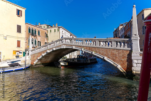 Scenic view of Guglie Bridge with skyline of the old town of Italian City of Venice on a sunny summer morning. Photo taken August 7th, 2023, Venice, Italy.