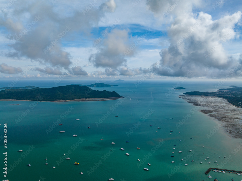 Aerial View Amazing sea with travel boats,sailing boats in the sea,Beautiful sea in summer season at Phuket island Thailand,Travel boats,Ocean during summer blue sky background