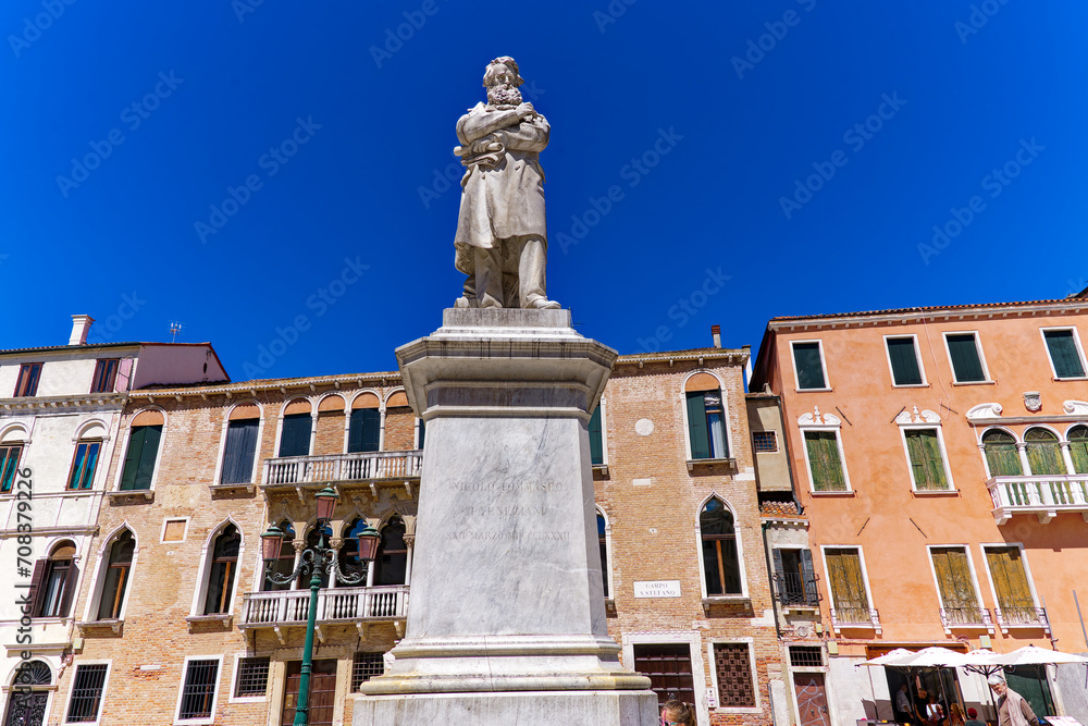 Old town of Italian City of Venice with square named Santo Stefano and statue of Nicolo Tommaseo on a sunny summer day. Photo taken August 7th, 2023, Venice, Italy.