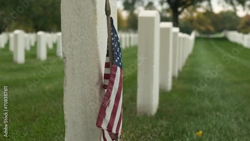 members graves with American flags at sunset in the National Cemetery. Unknown soldier grave. Veteran cemetery and U.S. flag. Military Appreciation Holidays concept photo