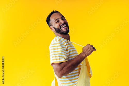 Image of an handsome young man posing on colored backgrounds wearing colorful trendy clothes. Concept about carefree, fashion and lifestyle