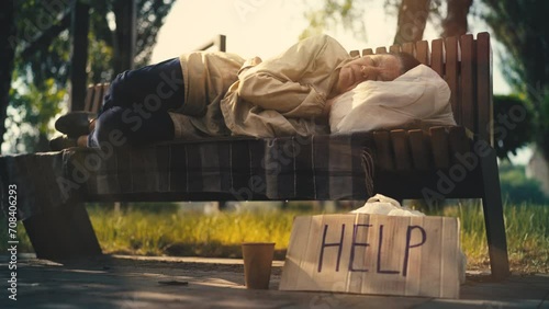 Cunning person stealing donations cup of homeless senior woman sleeping on bench photo