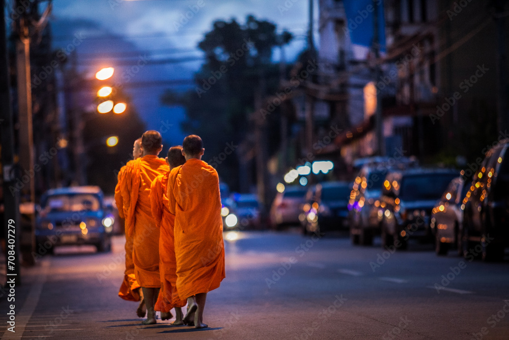 Obraz premium Buddhist monks are morning walking on routes villages in Bangkok, Thailand. Concepts make merit with monks in culture and religion and Thailand Travel.
