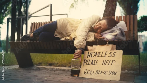 Please help cardboard sign, homeless woman sleeping on bench, social injustice photo