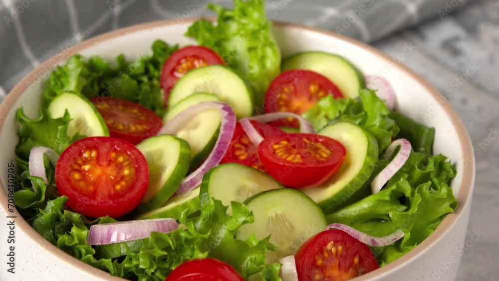 Proposing healthy eating. Vegetable salad with cucumber, tomato, onion and green salad 4k video close up Proposing healthy eating. Vegetable salad with cucumber, tomato, onion and green salad 4k video close up