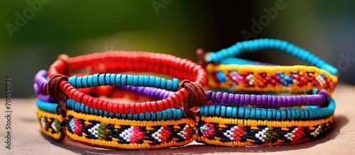 Friendship bracelets are crafted by weaving threads or beads, often symbolizing bonds of friendship. © TheWaterMeloonProjec
