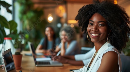 Group of African American employees or employees start-up creative design business working meeting sitting in workplace room, creative workers using technology laptop computer, teamwork entrepreneur