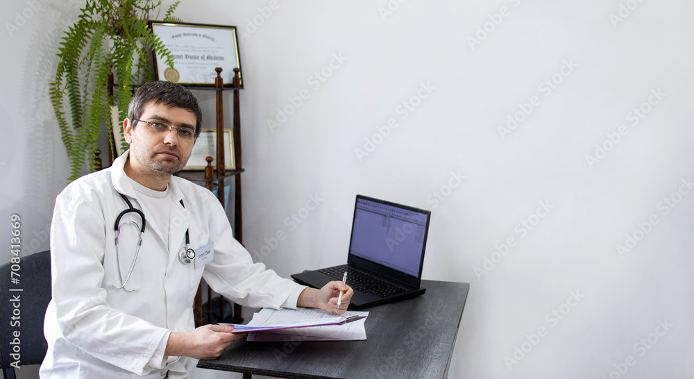 Doctor working on laptop. Portrait of a doctor. The doctor in the office. Confident doctor, professional Doctor working on laptop. Portrait of a doctor. The doctor in the office. Confident doctor, professional