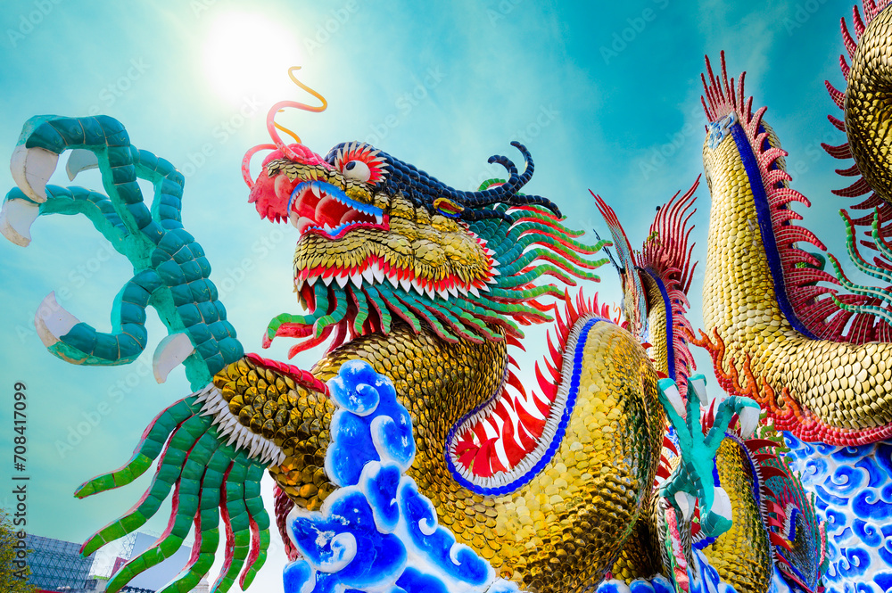 Fototapeta premium Golden dragon statue with blue sky