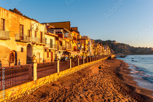 Fototapeta Naklejka Na Ścianę i Meble -  morning sunrise landscape on a city emnarkment with beach and sea coast and beautiful mediterranean street with buildings