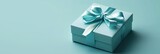 Minimalistic teal gift box with a sleek ribbon, perfect contrast on a soft green background